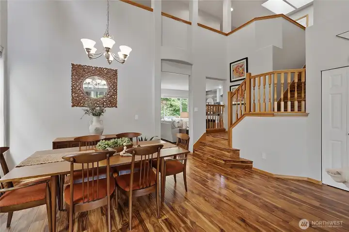 Host dinner parties in this sun-drenched dining area. The open-concept layout and high ceilings provide an airy atmosphere, while the proximity to the grand staircase adds a touch of architectural drama. Host dinner parties in this sun-drenched dining area. The open-concept layout and high ceilings provide an airy atmosphere, while the proximity to the grand staircase adds a touch of architectural drama.