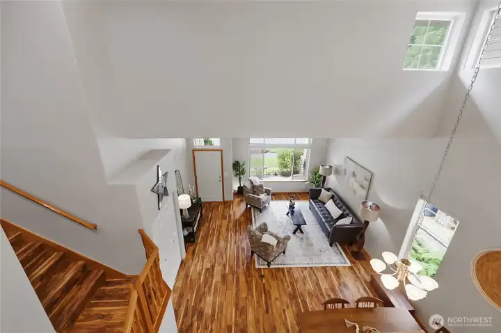 From the upper-level overlook, take in the breathtaking scale of the home’s architecture. This vantage point highlights the soaring vaulted ceilings and the seamless flow between the formal living areas below, emphasizing the home's open and bright design. From the upper-level overlook, take in the breathtaking scale of the home’s architecture. This vantage point highlights the soaring vaulted ceilings and the seamless flow between the formal living areas below, emphasizing the home's open and bright design.