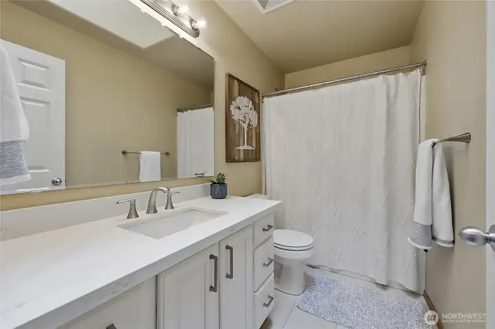 The secondary upstairs bathroom is thoughtfully designed with a spacious vanity, sleek chrome fixtures, and a clean, modern aesthetic. Serving the guest bedrooms, it features a full tub-and-shower combination and easy-to-maintain flooring. The secondary upstairs bathroom is thoughtfully designed with a spacious vanity, sleek chrome fixtures, and a clean, modern aesthetic. Serving the guest bedrooms, it features a full tub-and-shower combination and easy-to-maintain flooring.