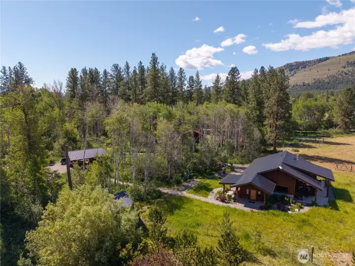 Surrounded by aspen groves, irrigated hay fields, and Mt. Gardner views, this light-filled, single-level home offers beauty from every window.