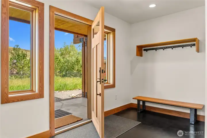 An oversized entry provides ample room for all your seasonal gear. Daniel Russell designed metalwork inside of home (towel bars, hooks etc)