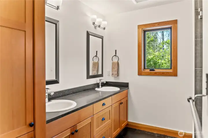 Double sinks and black soapstone countertops.