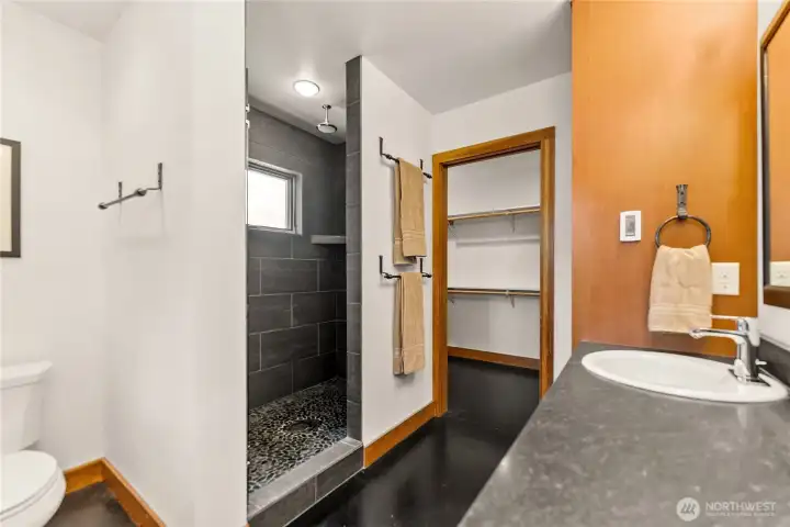 Tiled shower with rockery shower floor.