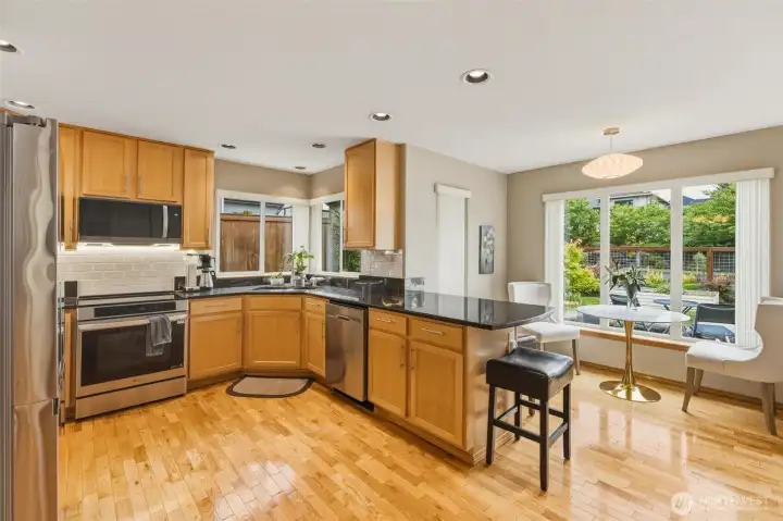 Spacious chef's kitchen with plenty of granite countertop space, storage cabinets, bar seating, breakfast nook, new appliances including induction stovetop/convection oven and splashed with tons of natural light . Spacious chef's kitchen with plenty of granite countertop space, storage cabinets, bar seating, breakfast nook, new appliances including induction stovetop/convection oven and splashed with tons of natural light .