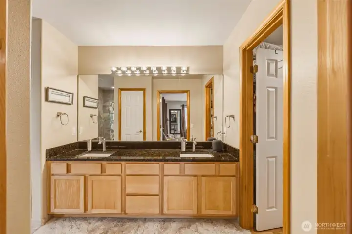 Large Primary bath with double vanity, granite countertops, radiant floor, newly remodeled tiled shower, soaking tub and huge walk in closet. Large Primary bath with double vanity, granite countertops, radiant floor, newly remodeled tiled shower, soaking tub and huge walk in closet.