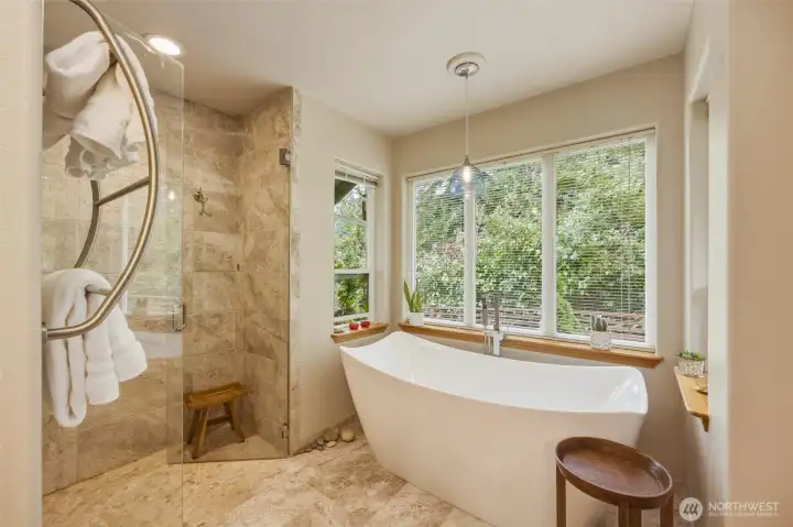 Stunning spa like newly remodeled walk in shower and bath looking out to the NW beauty of evergreens . Stunning spa like newly remodeled walk in shower and bath looking out to the NW beauty of evergreens .