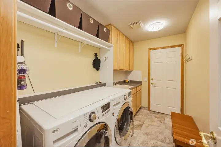 Laundry room loaded with storage. Laundry room loaded with storage.