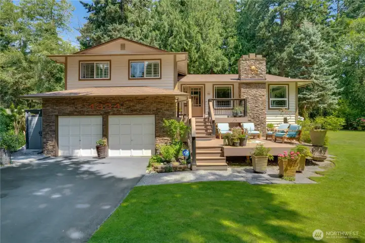 Stacked stone, copper sun & composite front deck — curb appeal earned over four decades. Stacked stone, copper sun & composite front deck — curb appeal earned over four decades.