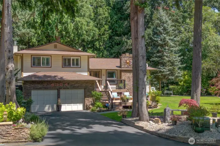 Freshly sealed driveway, rockery beds & a 2-car garage tucked into the trees. Freshly sealed driveway, rockery beds & a 2-car garage tucked into the trees.