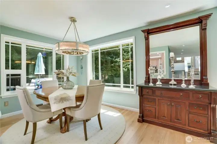Sunlit dining room overlooking the gardens — hardwoods refinished in 2024. Sunlit dining room overlooking the gardens — hardwoods refinished in 2024.
