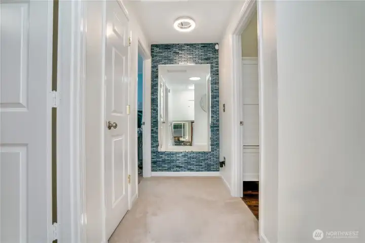 Glass-tile gallery wall and solar tube brighten the upper landing. Glass-tile gallery wall and solar tube brighten the upper landing.