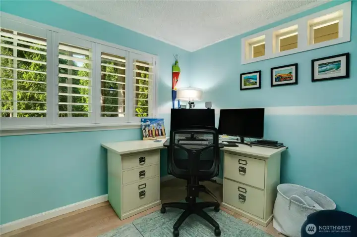 Third bedroom makes a crisp home office — shutters, transom windows & forest views. Third bedroom makes a crisp home office — shutters, transom windows & forest views.