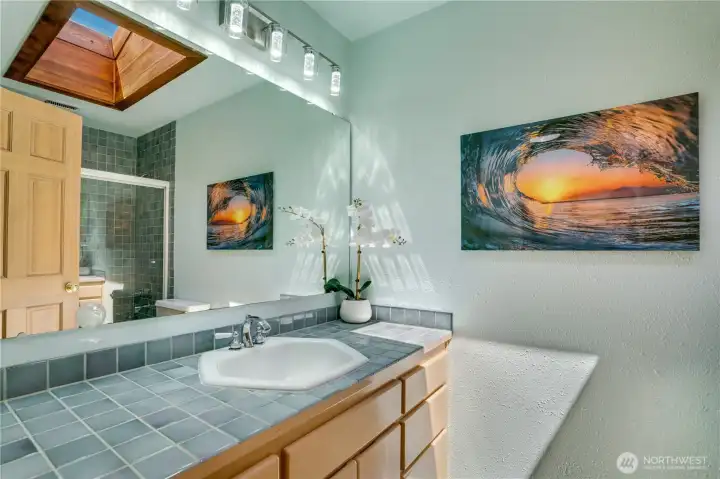 Skylit hall bath with cedar-framed skylight and coastal tile. Skylit hall bath with cedar-framed skylight and coastal tile.