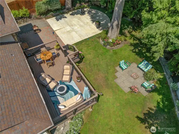 From above: deck, 900 sq ft sport pad, fire pit patio & level lawn on a third-acre. From above: deck, 900 sq ft sport pad, fire pit patio & level lawn on a third-acre.
