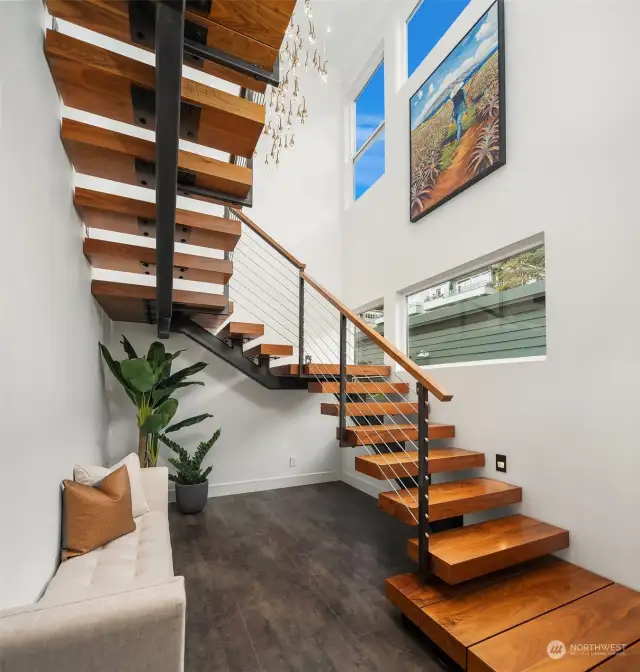 The upper and lower floors are connected by a breathtaking stairway with walnut treads and railings with steel industrial-style support.