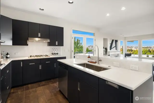 Renovated main-level leisure kitchen with new cabinets sink, countertops, microwave/oven and stove-top.