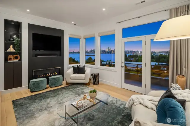 Beautiful views from the living room! Fireplace upgraded with full-view liner, modern model. The fireplace and TV are framed with single-slab black honed/leather granite. Lighted fireplace niche cabinet lined with black-stained walnut.