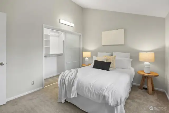 A well-appointed spare upstairs bedroom featuring a custom-designed closet, offering both style and functionality for versatile use.