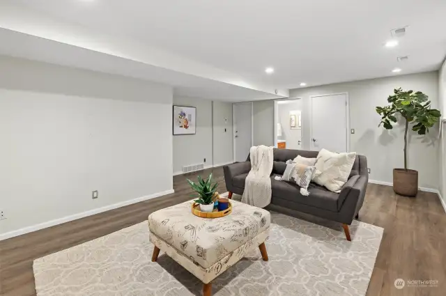 A flexible game room or bonus space with convenient access to a powder bath, laundry room, and garage, combining functionality with entertainment.