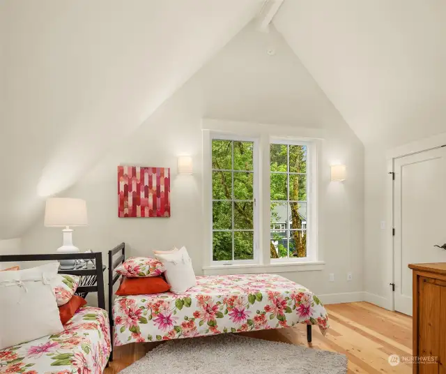 One of the two vaulted ceiling bedrooms is filled with light from the south facing windows.