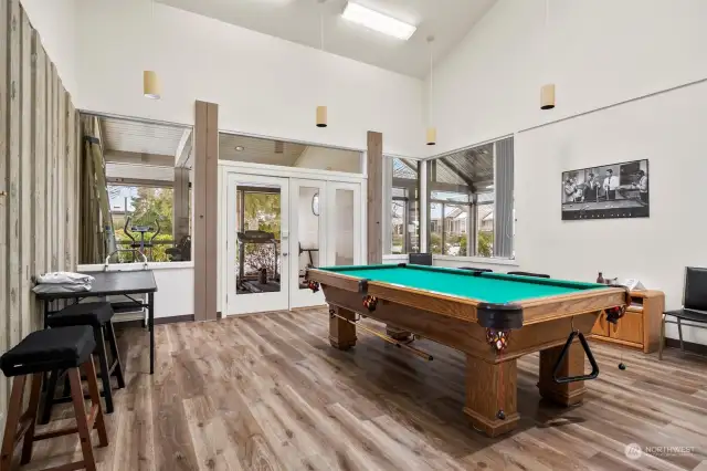 Game room with pool table and small exercise room.