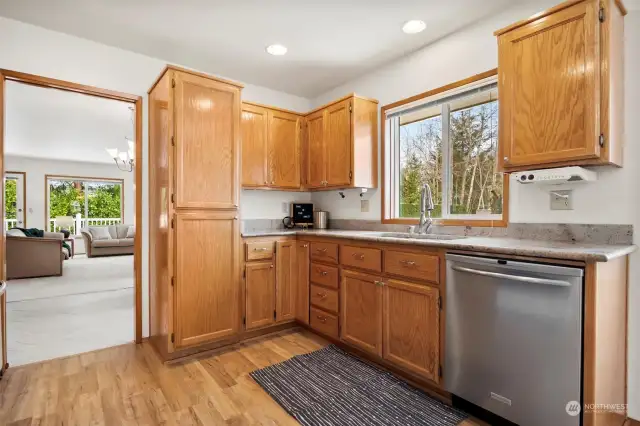 Updated kitchen with wood cabinets and granite countertops.