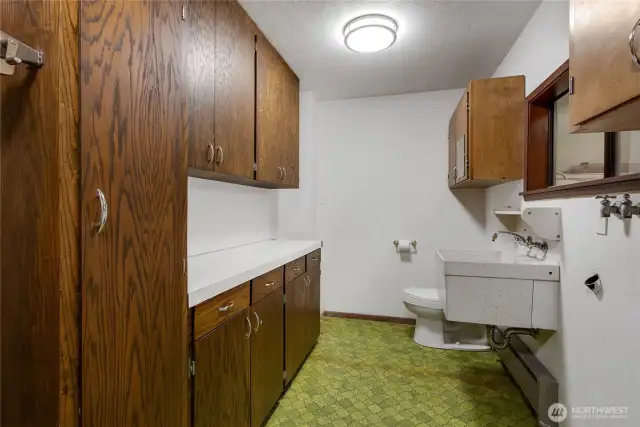 Seperate laundry room with toilet and sink