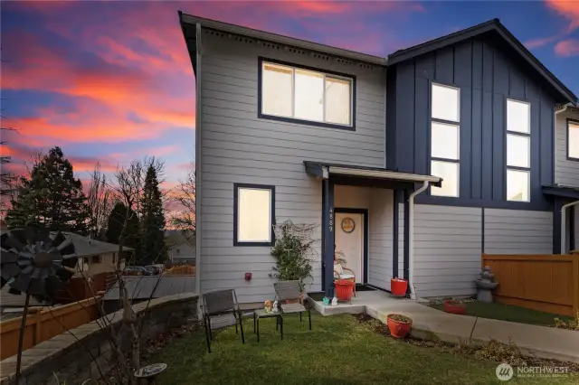 This remodeled townhouse with modern architecture offers stylish contemporary living. This townhouse has two entries. One entry opens on the main level located next to the garage and this pictured entry opens to the upper level with a great room.