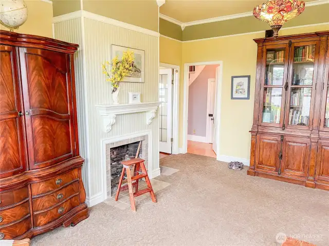The living room here, and parlor connect with a doorway just right of the fireplace.