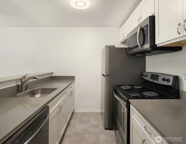 Updated cabinetry, flooring & quartz counters