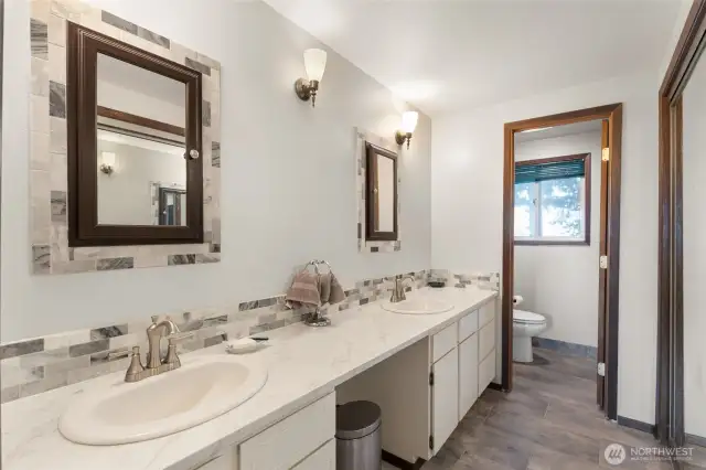 Recently updated Primary bath with granite countertops at the double vanity.