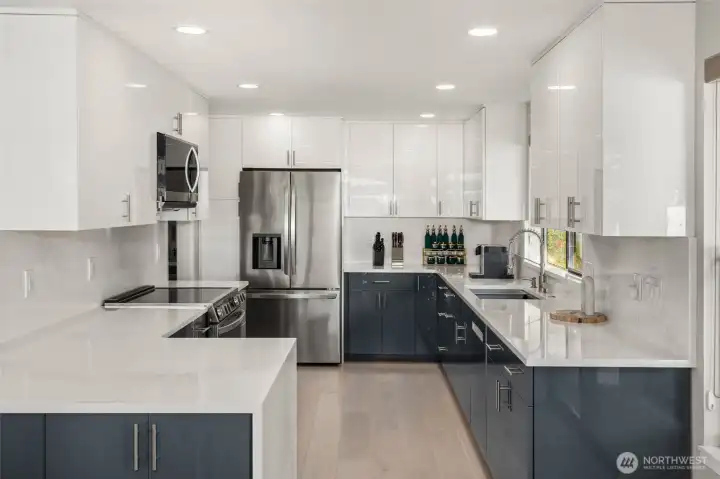 Beautiful kitchen remodel with high-end appliances, quartz countertops and sleek custom cabinets.
