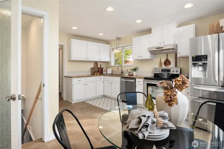 Just off the living room is this large kitchen with tiled floors and gracious dining area.