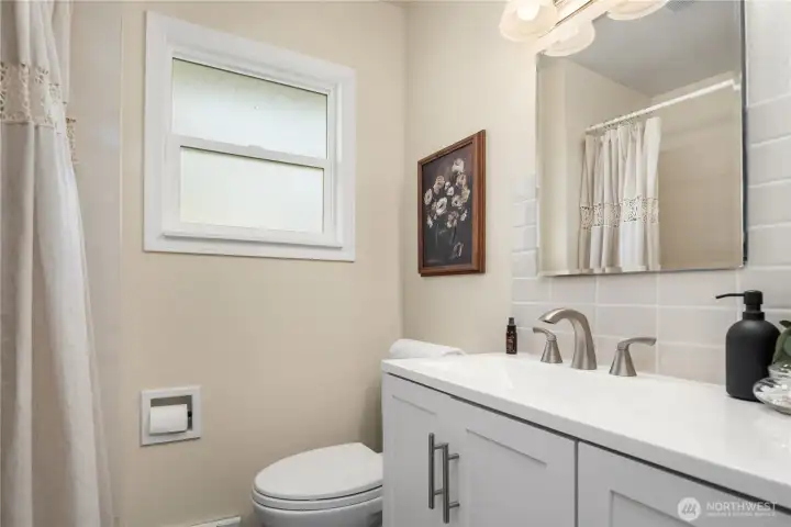 This is one of 2 bathrooms. The main floor bath features a new vanity and full size bathtub. Plumbing has been updated throughout the house.