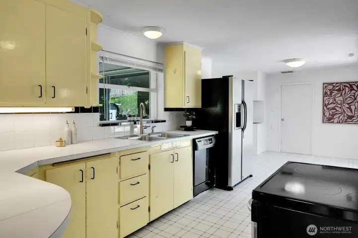 The spacious kitchen has a double stainless sink, under cabinet lighting and lots of storage.