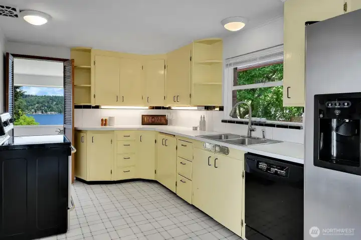 Retro, built-in shelving on the upper cabinets add to the mid-century feel.