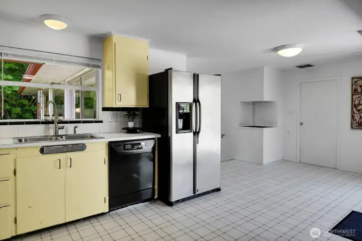 The kitchen is open to an informal dining space.