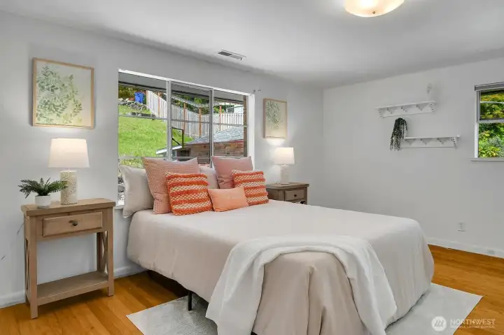 Roomy and comfortable, the second bedroom features more of those warm hardwoods. There are also 2 closets and built in drawers on the adjacent wall!