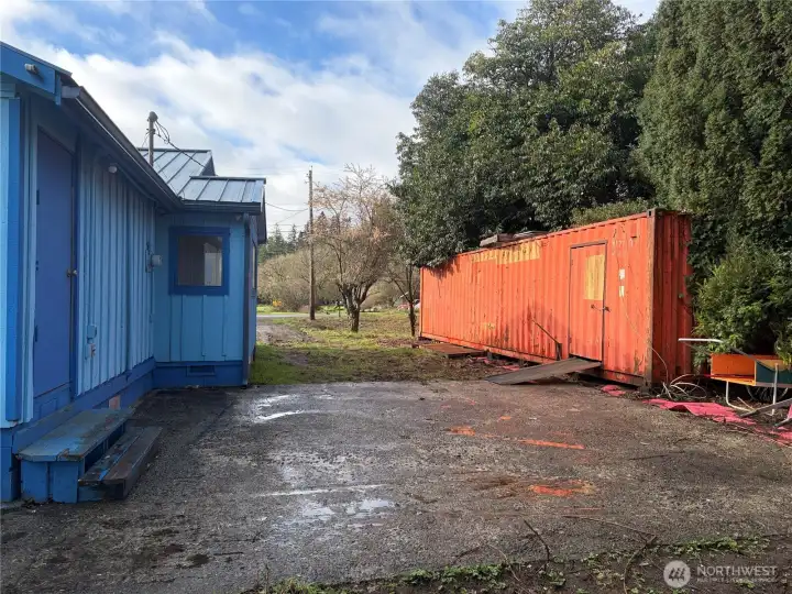 Side of home of home and storage container.