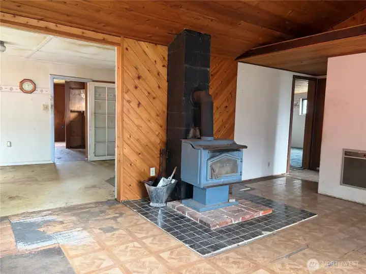 Electric wall heat with wood stove for back up. Kitchen /dining room to left. Bedrooms and full bath to the right.