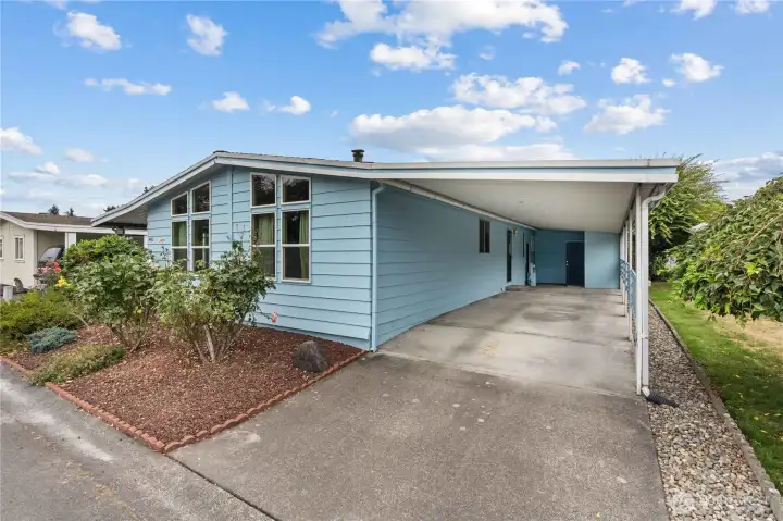 Carport has 2 parking spots and storage units.