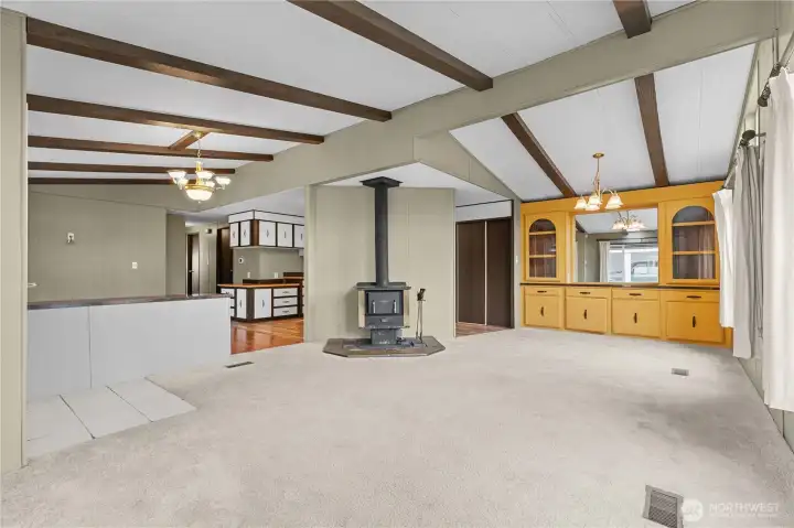 Another angle of large living/dining great room area with vaulted ceilings and open floorplan.