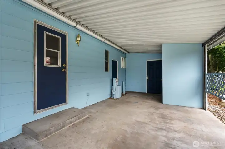 Carport is clean and spacious and has two storage areas.