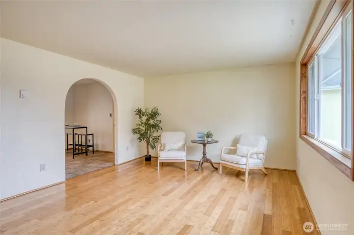 Spacious living room with large picture window and easy flow into the kitchen
