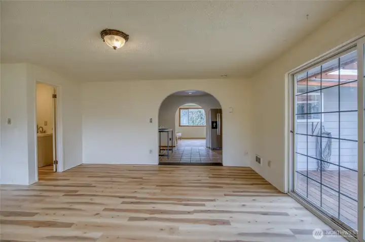 The family room offers incredible flexibility, with a new wood stove for cozy evenings and a sliding glass door opening to the spacious backyard for easy indoor-outdoor living