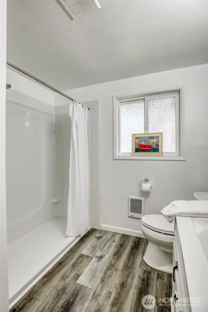 Bright, refreshed bathroom with updated vanity and walk-in shower