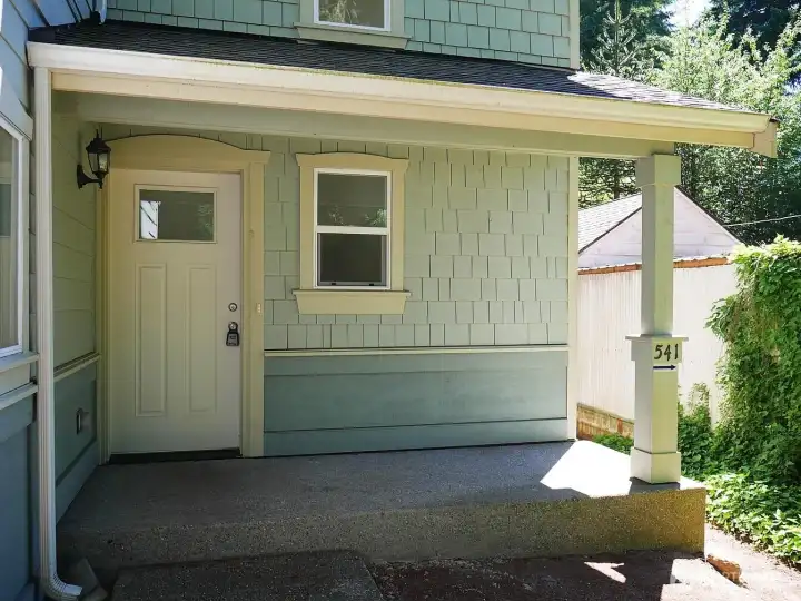 The 2013 building has an attached 2 car garage that has two separate bays, one for upper 3 BR unit and the other for lower 2 BR unit. This covered porch shown here is for Unit #543 and you can see on the post an arrow pointing around back where you will find entry to Unit #541. The 2013 building has an attached 2 car garage that has two separate bays, one for upper 3 BR unit and the other for lower 2 BR unit. This covered porch shown here is for Unit #543 and you can see on the post an arrow pointing around back where you will find entry to Unit #541.