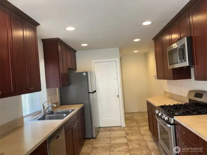 Large Galley kitchen with 2nd bathroom beyond. Ample cabinet package, gas cooktop and stainless steel appliances. Large Galley kitchen with 2nd bathroom beyond. Ample cabinet package, gas cooktop and stainless steel appliances.