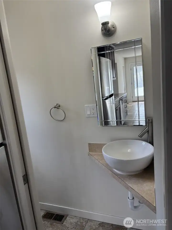 Medicine cabinet with beveled mirror design in powder room. Medicine cabinet with beveled mirror design in powder room.