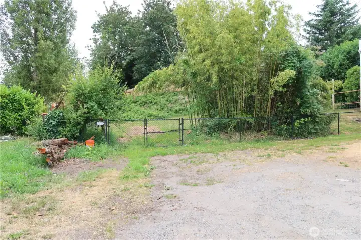 Parking area and gate to back yard area.